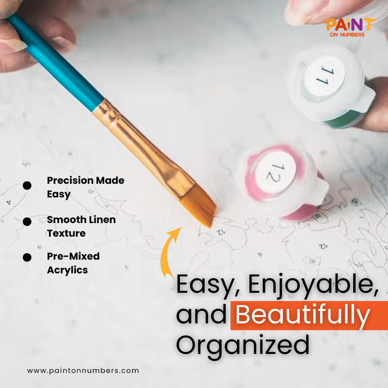 Close-up of hand holding numbered acrylic paint pots and a gold-edge brush painting on a detailed paint by numbers canvas with smooth linen texture, highlighting precision, ease, and pre-mixed colors from Paint On Numbers.