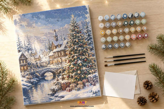 Paint by numbers Christmas kit on a timber table with festive decorations pine branches and fairy lights in a bright Australian summer home