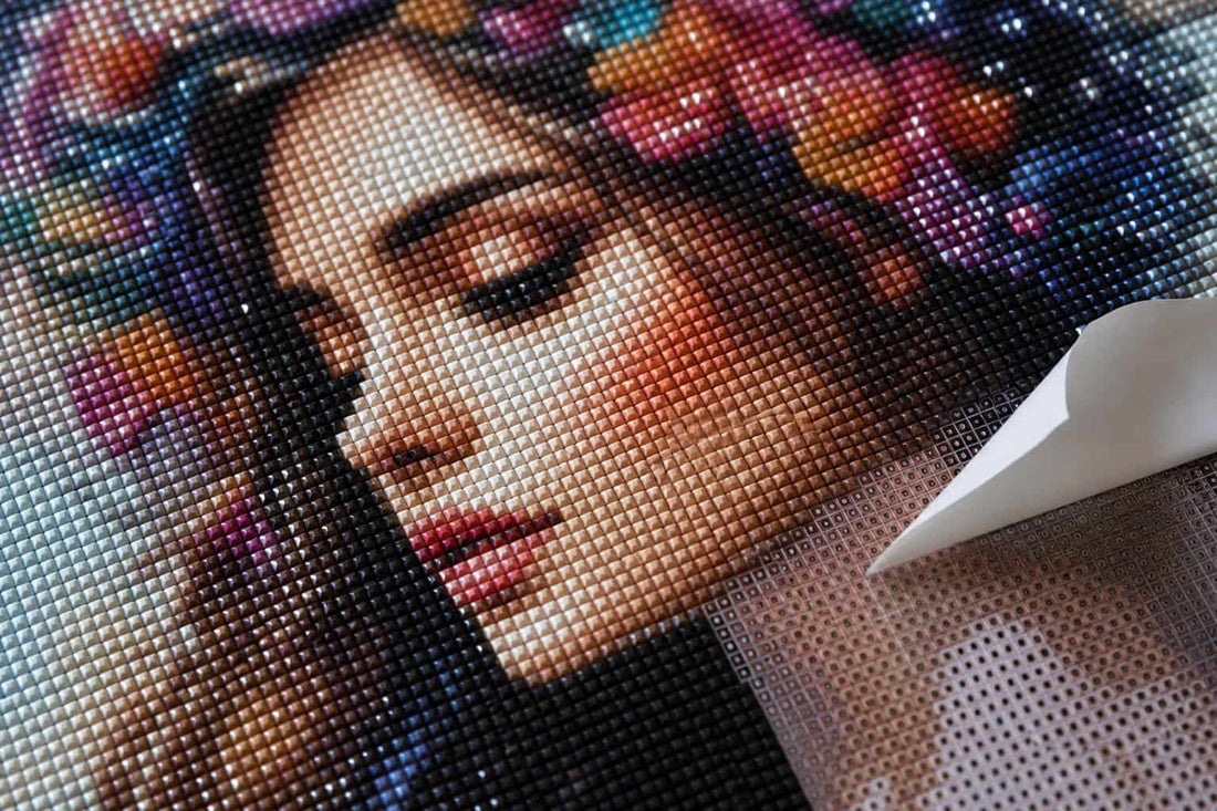 A custom diamond painting kit in progress showing a family portrait being recreated in resin diamonds on an adhesive canvas