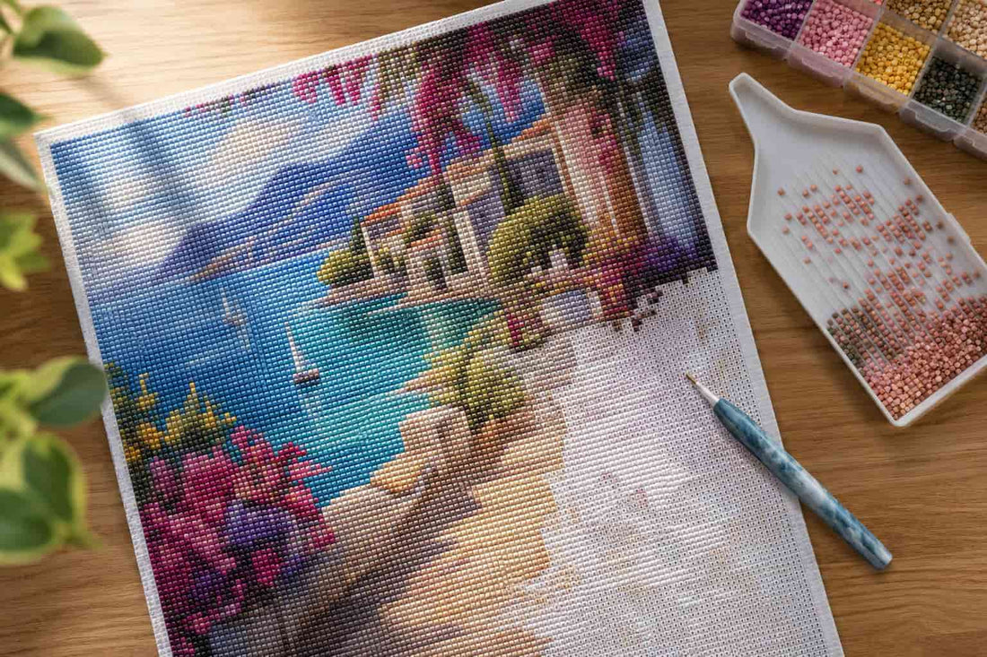 A diamond painting canvas with thousands of tiny resin diamonds partially placed, showing a vivid landscape design in progress on a flat work surface