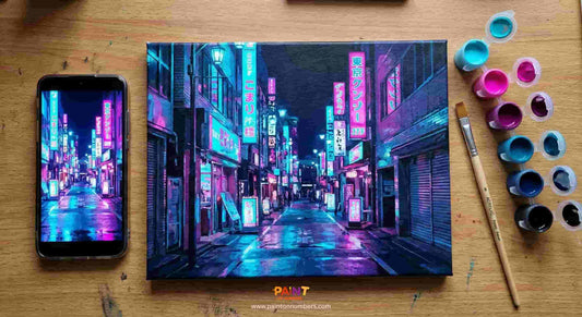 Neon cityscape painting on a wooden surface with a phone displaying a similar scene.