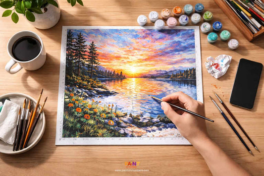 A person deeply focused on a paint by numbers canvas, with their smartphone placed face down to avoid distractions.