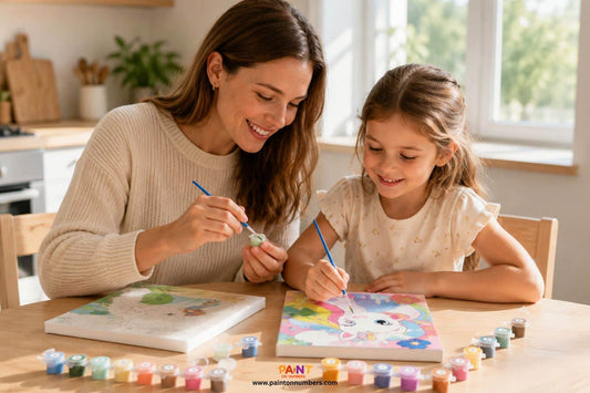 Mother and daughter enjoying painting together at a table with paint by numbers kits, colorful paint pots, and brushes in a bright, sunlit home.