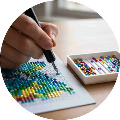 Person working on a cross-stitch project with a box of colorful beads.