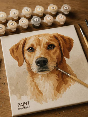 Canvas with a dog portrait, paint tubes, and brushes on a wooden surface