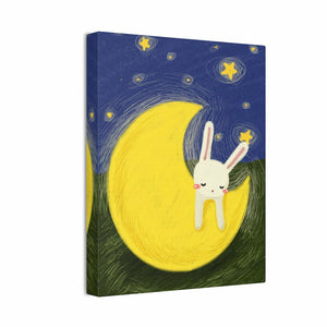 Canvas print with a cartoon bunny on a yellow moon against a starry night sky.