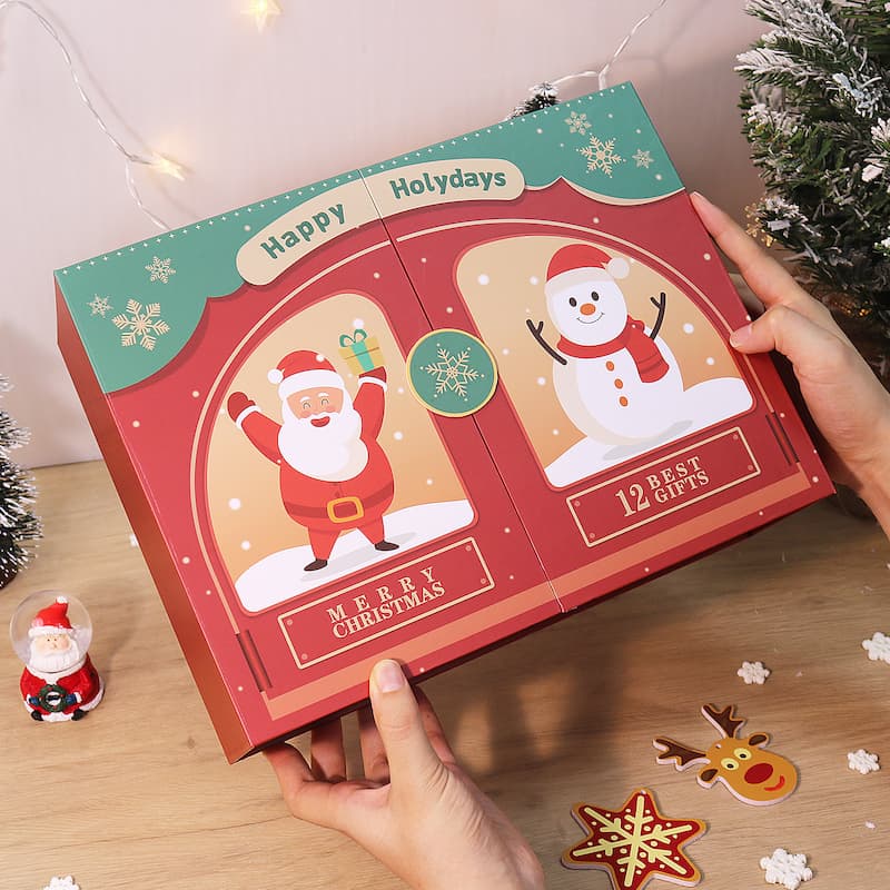 Christmas-themed advent calendar with Santa Claus and snowman designs, held by a person.